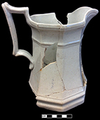 Panelled white granite pitcher, octagonal. Height to top of handle: 7.75”; Rim Diameter: 4.50”; Base diameter: 5.00” - from 18BC27.